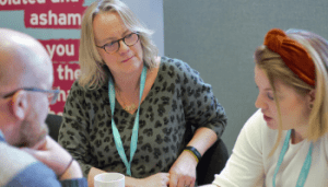Three people sat having a conversation