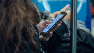 Person sat with phone in hand