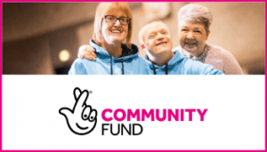 Three people close together smiling - Community Fund logo