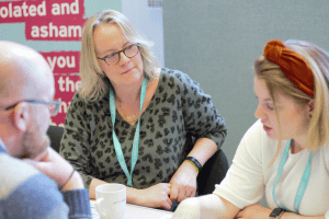 People sat around a table talking