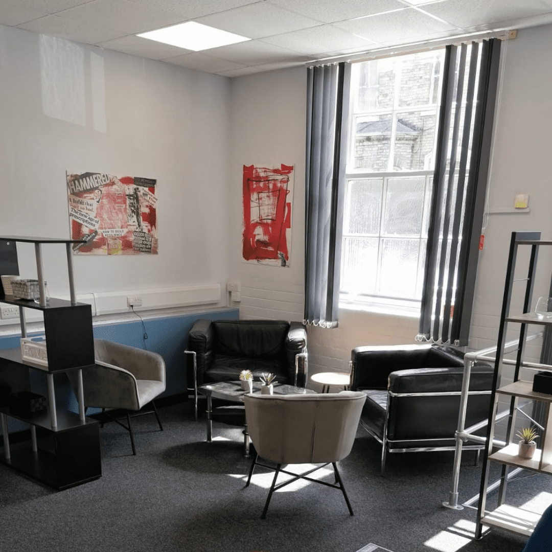 Co-location spaces In the corner next to a large window there are 4 comfortable chairs with a coffee table in the middle