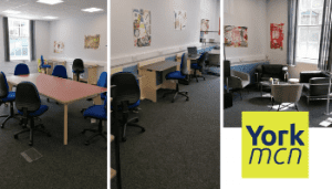 Image of office space with meeting table and chairs and individual office desks and chairs