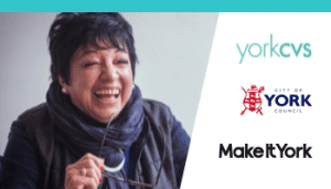 Female with short dark hair holding her glasses and laughing - Photo Credit Peter Kindersley Centre for Ageing Better