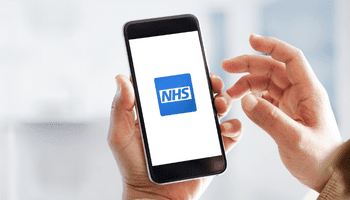 NHS App - Website Picture of a person holding a mobile phone with the NHS Logo on