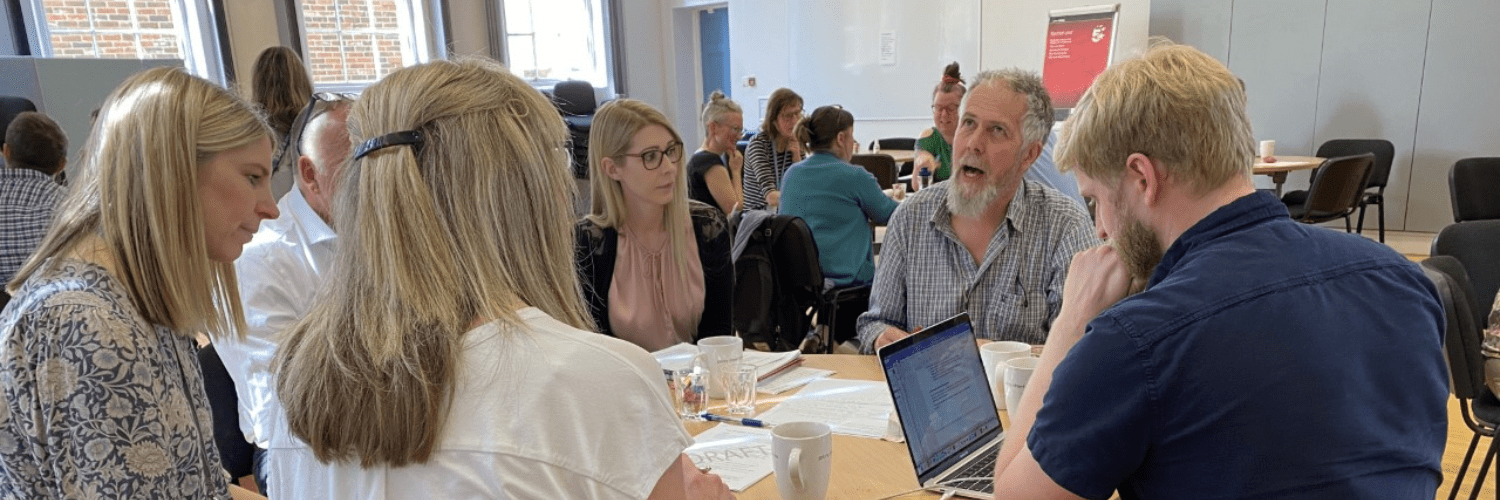 York VCSE Assembly Close up photo of a group of people having a discussion around a table