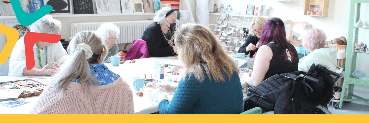 Craft and Cuppa Group Group of people sat down round a table doing different craft activities