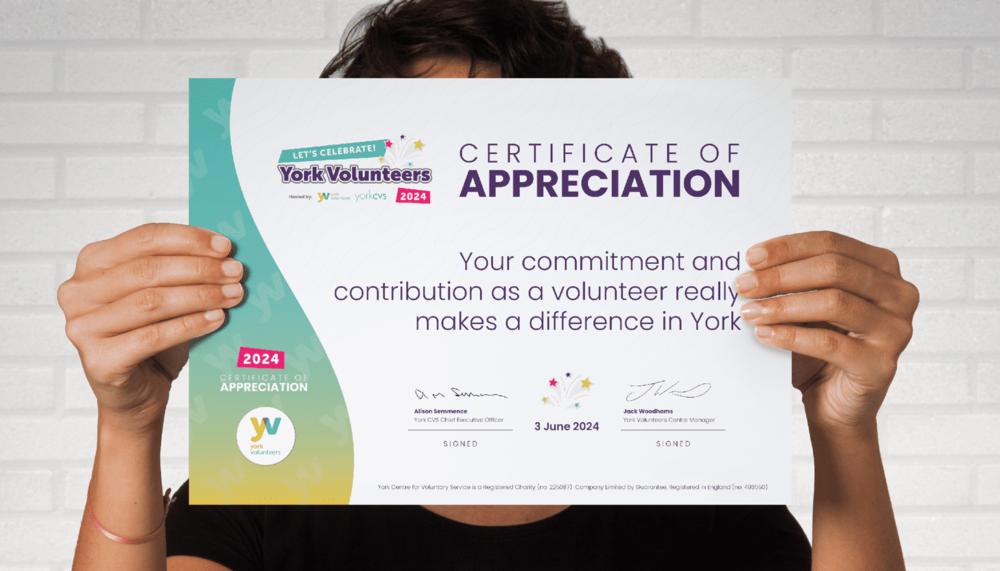 Certificate of Appreciation Image shows a person holding up a certificate in front of their face
