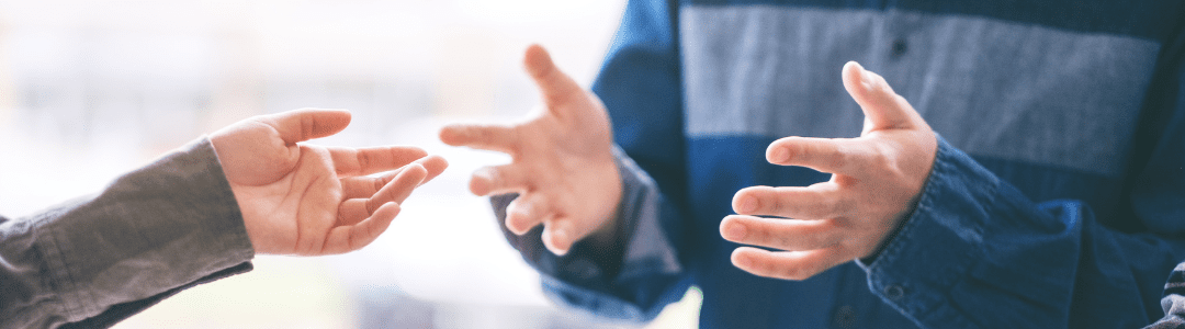 Healthwatch Hands gesturing people having a conversation explaining a topic of discussion.