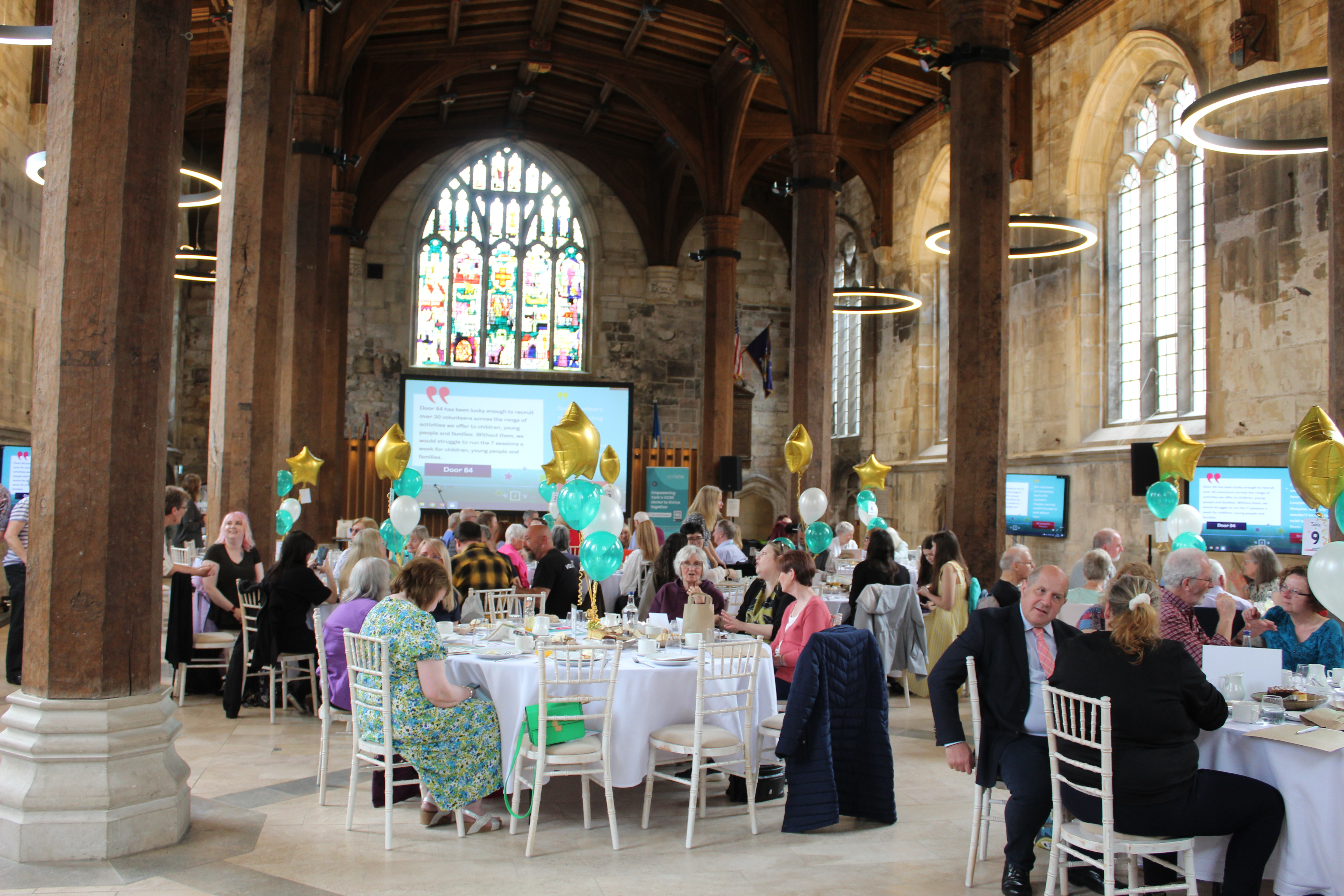 Let's Celebrate! York Volunteers - York Guildhall York Guildhall during the Let's Celebrate York Volunteers Event. The tables are adorned with gold and teal balloons.