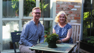 Image of Lee Probert and Alison Semmence sat down in the Priory Street Centre Courtyard