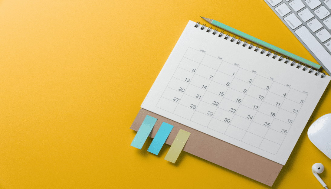 A calendar on a desk with a keyboard and mouse