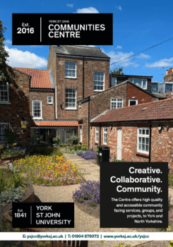 Exterior view of York St John Communities Centre with brick buildings and a colorful flower garden under a clear blue sky.