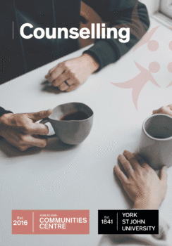 Two people sitting at a white table holding coffee mugs during a counselling session at York St John Communities Centre.