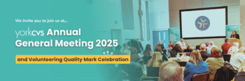 Image of people sat in the Main Hall at the Priory Street Centre - Text reads 'York CVS Annual General Meeting 2025'