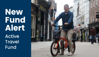 York and North Yorkshire Mayor, David Skaith, riding an orange folding bike on Coney Street in York