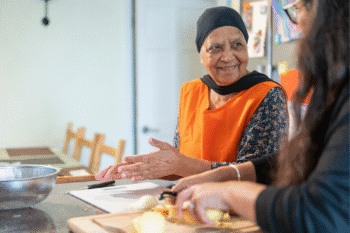 Image of an older woman and a younger woman of colour meal prepping together