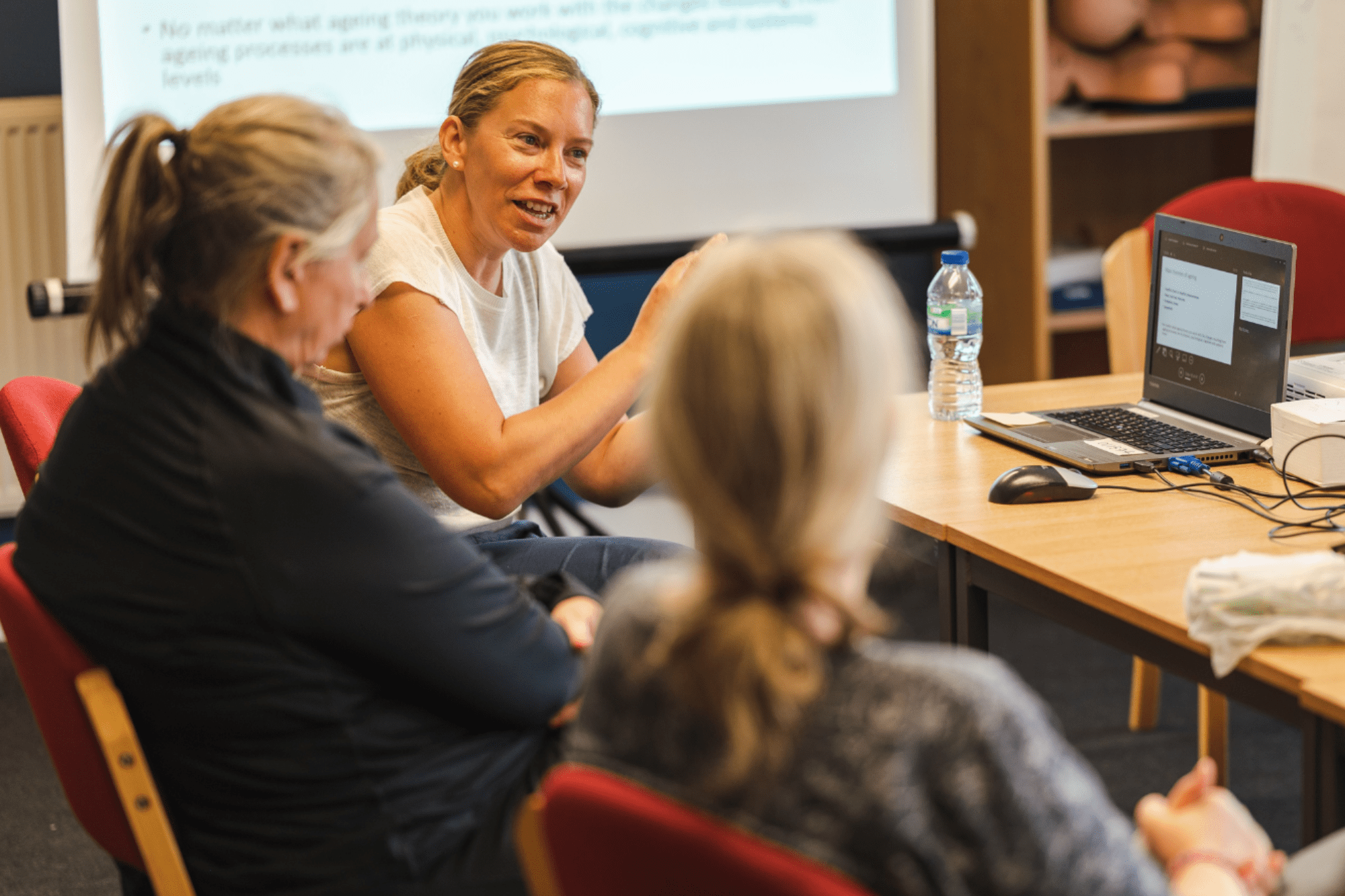 Image of people sat round a table talking