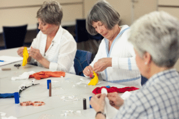 Image of three women sat down together at a art session