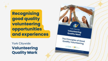 A promotional graphic for the York Citywide Volunteering Quality Mark. On the left, a yellow speech-bubble shape contains the text “Recognising good quality volunteering opportunities and experiences.” Below it reads “York Citywide Volunteering Quality Mark” in dark blue. On the right, there is an angled booklet cover featuring a group of smiling volunteers standing in a circle with their hands joined in the centre. The booklet title reads “York Citywide Volunteering Quality Mark – The Principles of Good Quality Volunteering,” with the York CVS and York Volunteers logos at the bottom. The background includes subtle gold star and line illustrations