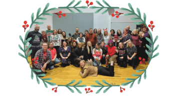Image of the York CVS staff team together in the Main Hall at the Priory Street Centre