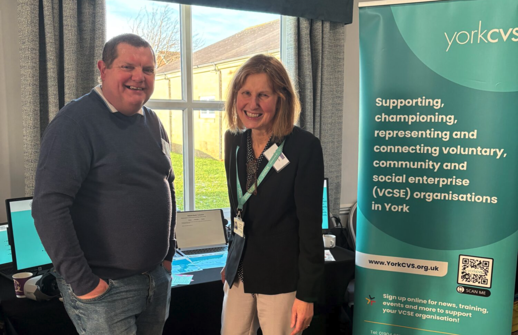 Michael Fletcher and Jane Granville stand beside a York CVS Pull up banner.