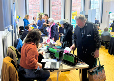 People speaking to stand holders about their volunteering opportunties