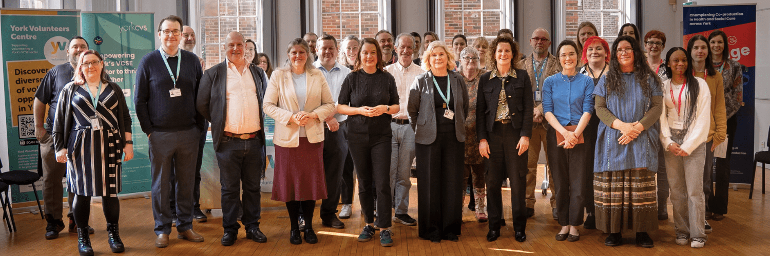 Group of people stood in the Main Hall at the Priory Street Centre 