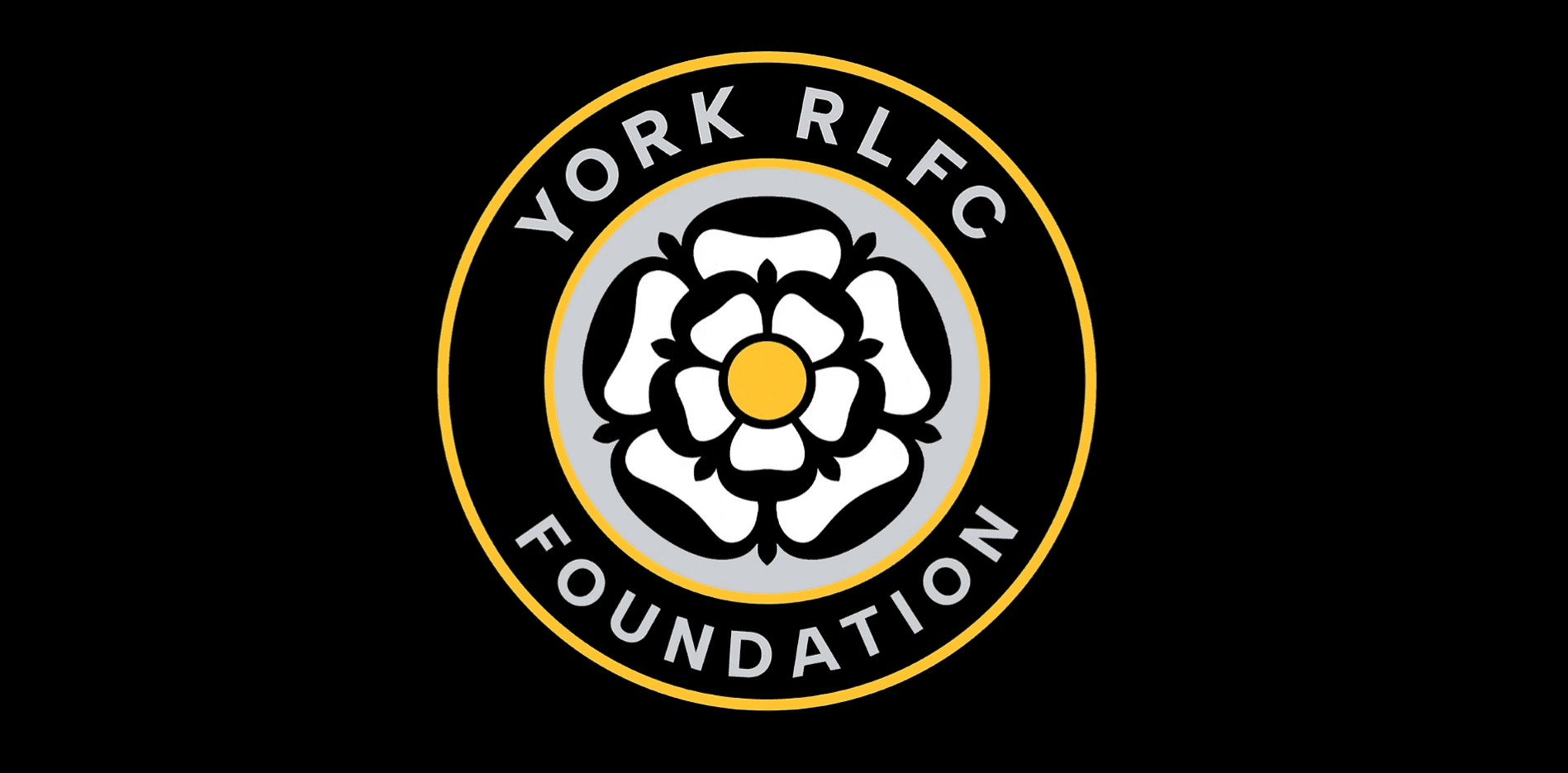 York RLFC Foundation logo showing a white rose emblem inside a circular black and gold badge with the words “York RLFC Foundation”.